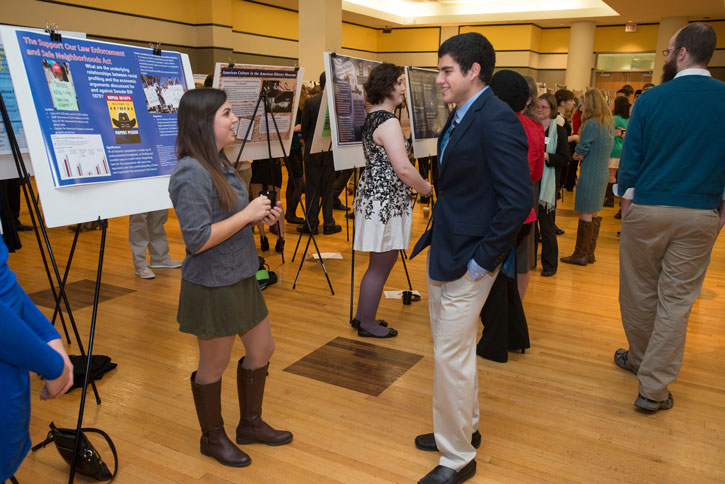 Students chat in front of posters