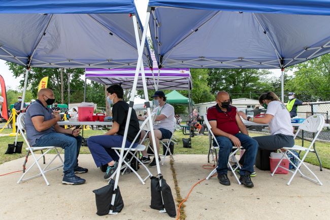 Residents of the Audubon Estates community receive COVID-19 shots at a Mason mobile vaccination clinic