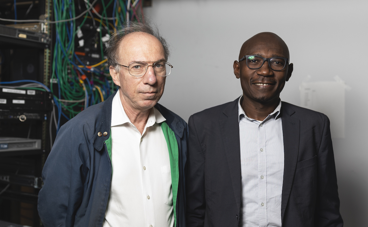 Mason's J. P. Auffret with Serge Adouaka on the Fairfax Campus during Adouaka's visit to Mason in 2019. Photo by Lathan Goumas/Strategic Communications