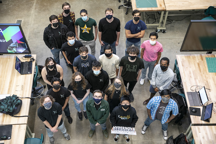 Michael Riggi and members of George Mason University's solar car team, Hypernova Solar, pose for a group photo.