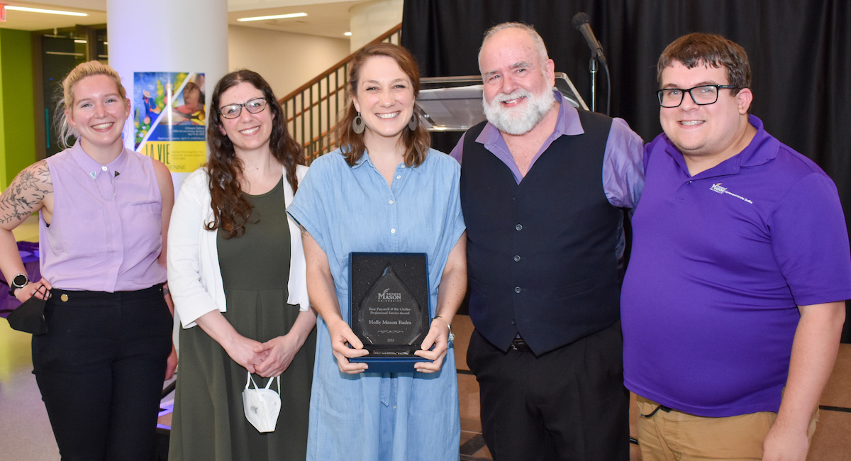 group of people with woman holding an award