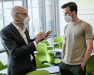Schar School junior public administration student Andrew Strasberg gains additional insight from Ezekiel Emanuel following the last class.
