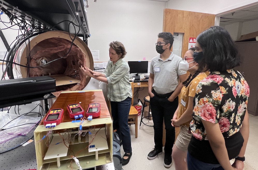 masked students in a lab with a researcher