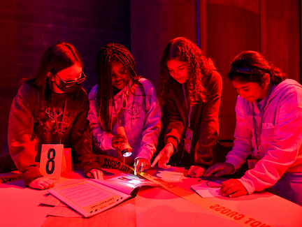 girls at a table under strange lighting