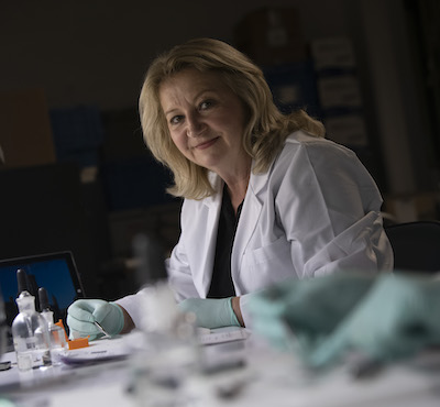 woman in white coat in her lab
