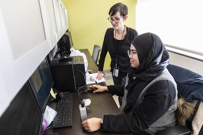 Jenna Krall and grad student at a computer