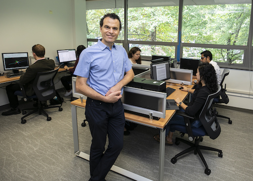 Ascoli with researchers at computer stations
