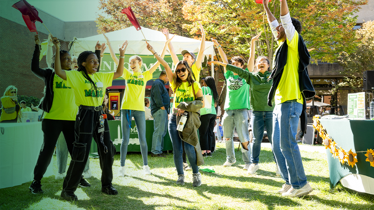 A group of Mason Ambassadors celebrate together at an admissions event.