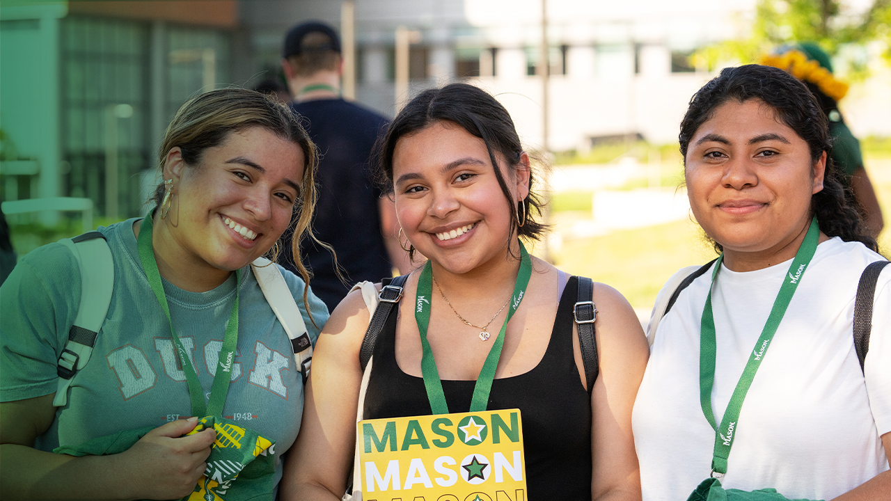 A group of incoming students smile together at an orientation event.