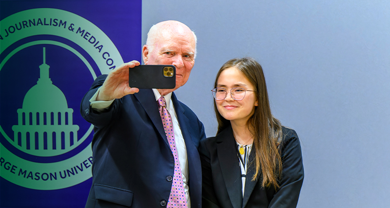 Brian Lamb poses for a photo with a WJMC attendee.