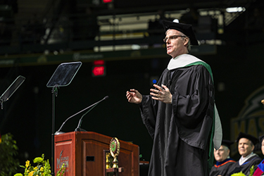 Speaker Paul Meizner addresses the graduates.