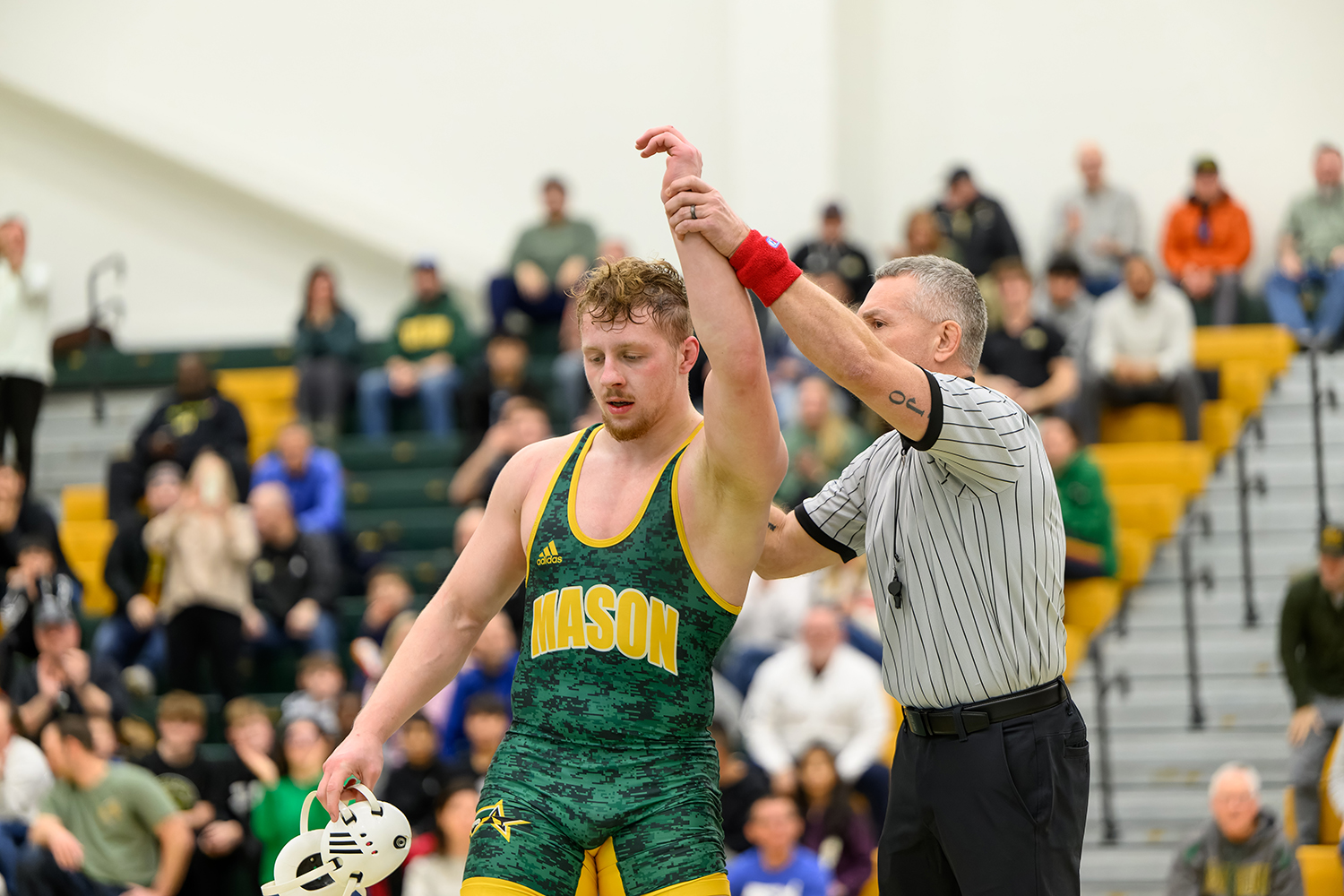 Kocak with his arm raised by a referee, declaring victory in one of his matches