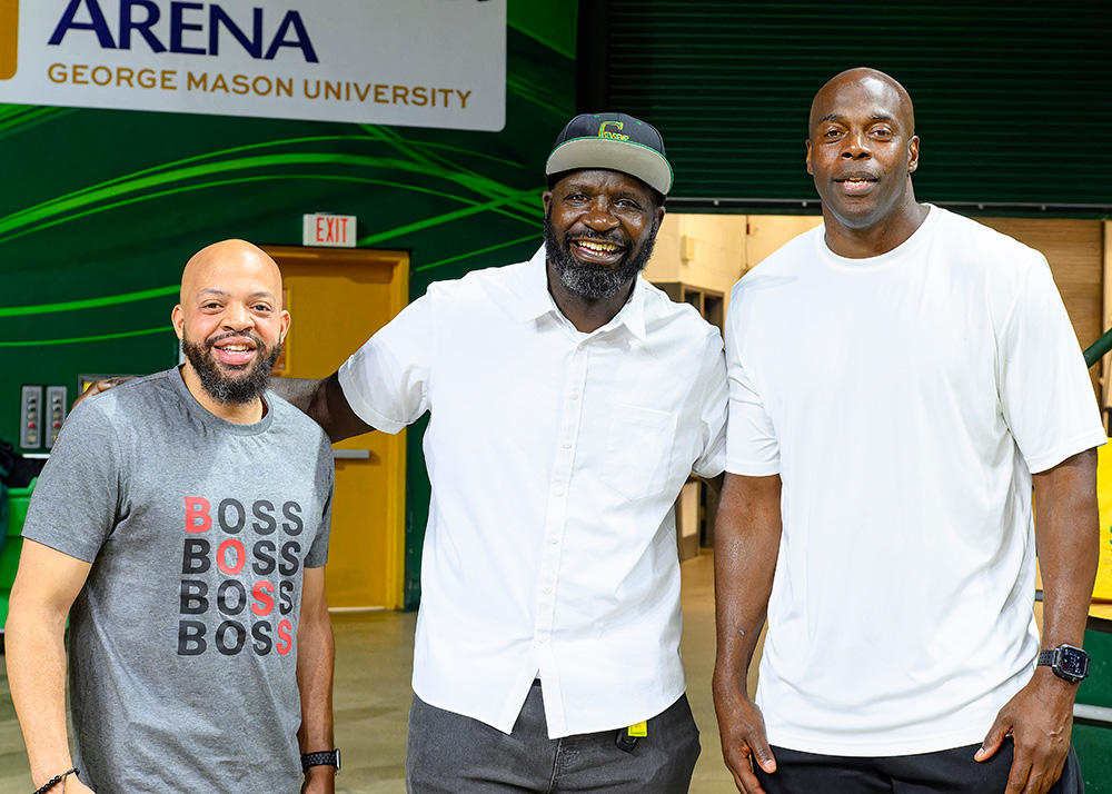 Three men pose for a photo.