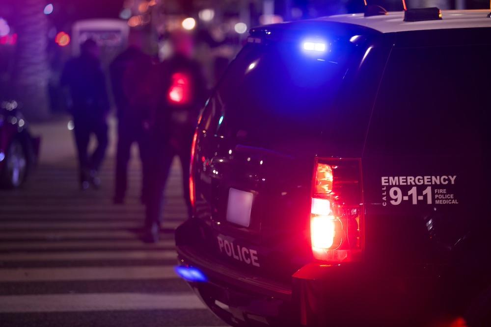 A police car parked beside a crime scene
