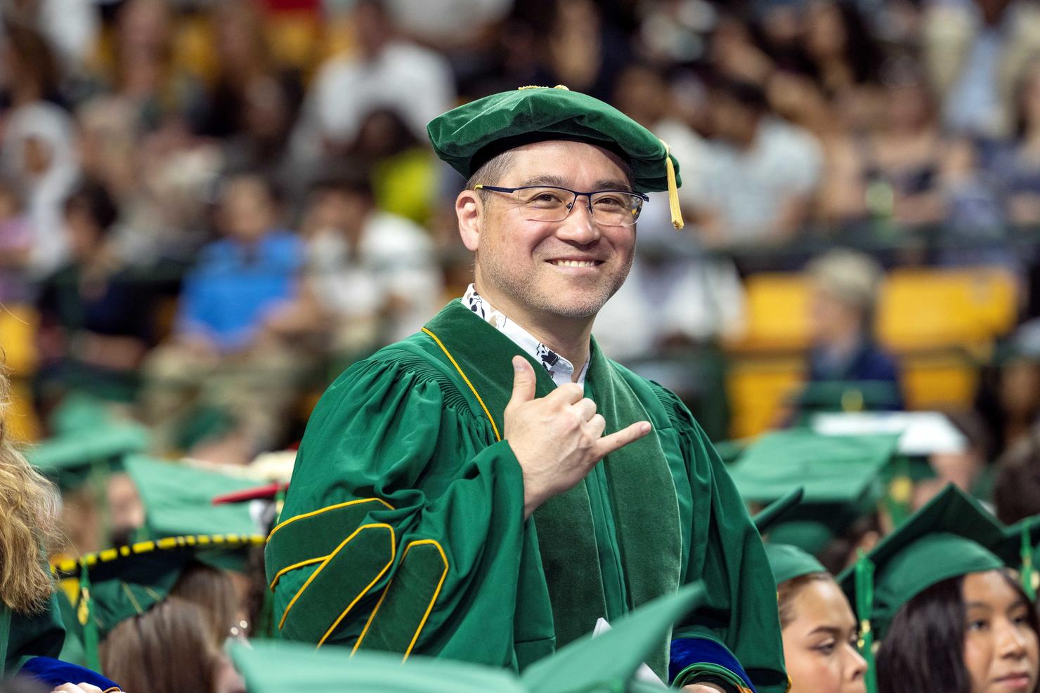 Graduate smiles in the crowd