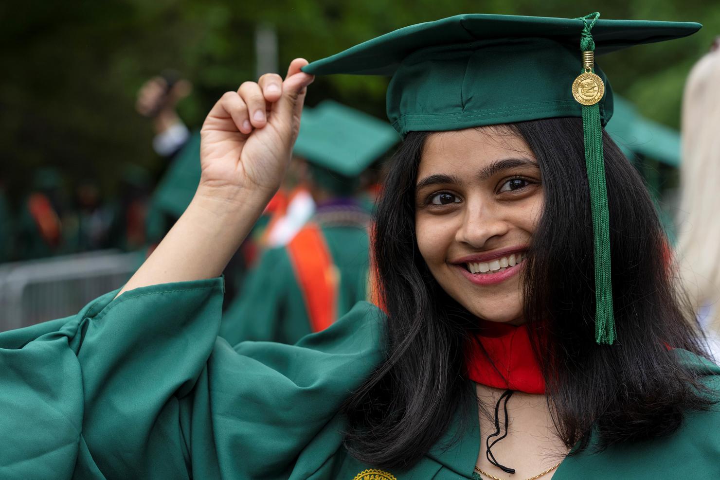 Graduating student tips her cap and smiles