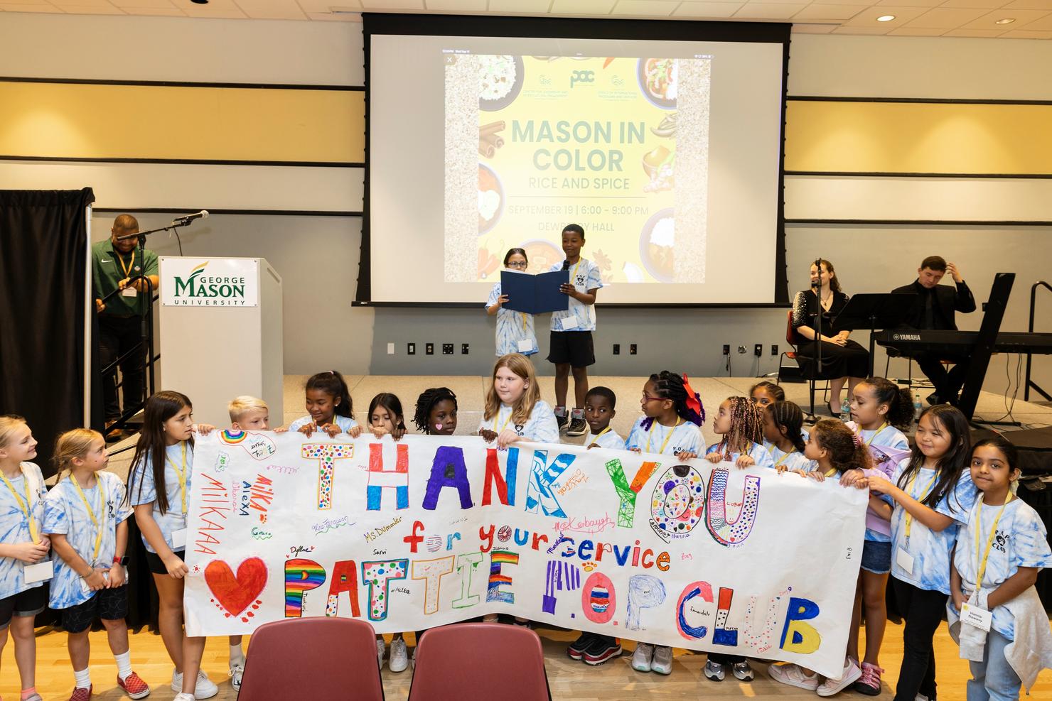 Students from Pattie Elementary hold a "thank you" banner