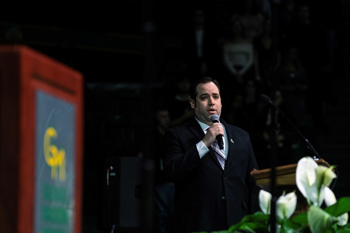 Ross Calvin, music student, performs the national anthem at Commencement