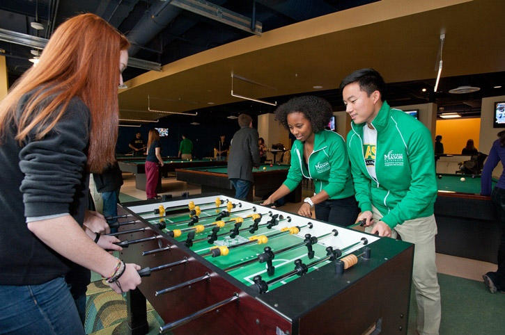 Students play foosball at Corner Pocket in The Hub on Fairfax Campus.