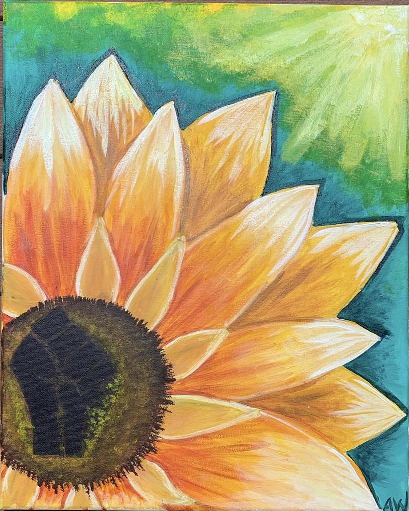 a flower with yellow and orange petals, brown center rests against a background of blues and greens.