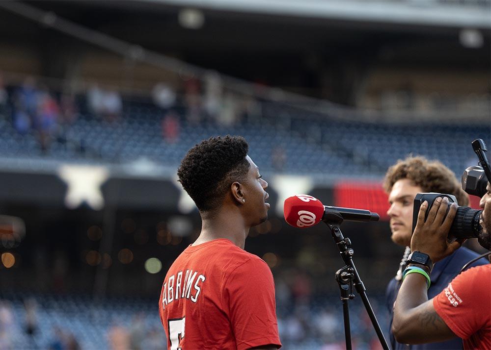 Alumnus Brandon Showell sings the national anthem.