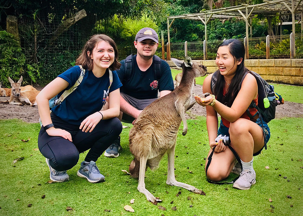 Students pose with a kangaroo in a refuge.