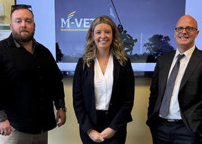 Two men and one woman pose for the camera
