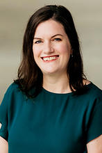 Courtney Wooten is wearing an emerald green short-sleeved top