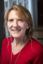 Melissa Ainsworth is wearing a red v-neck sweater