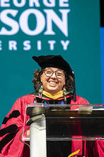 Gabrielle Tayac is shown in regalia at graduation at EagleBank Arena