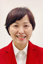Eunmee Lee is wearing a white collared shirt and red blazer