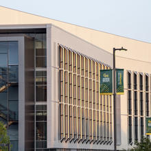 A building on SciTech campus with a George Mason University banner in front of it.