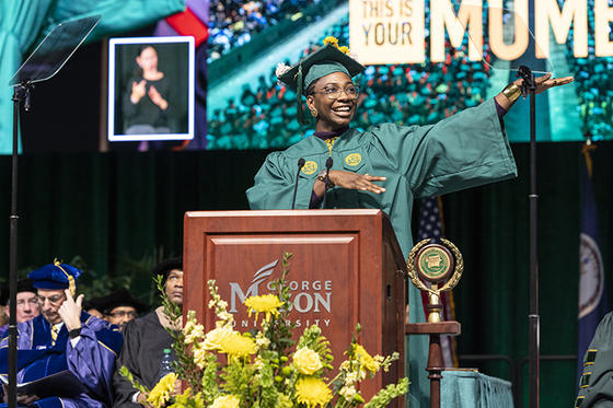 Yasmin Alamin stands at the podium at winter graduation