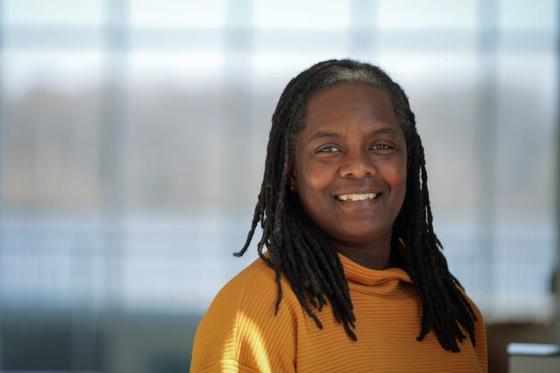 Photo of a female staff member smiling, with a blurred background