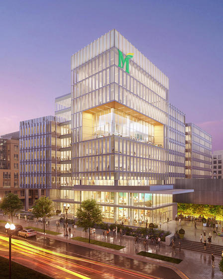 A mockup of the future Fuse building at dusk, with people walking in and around it.