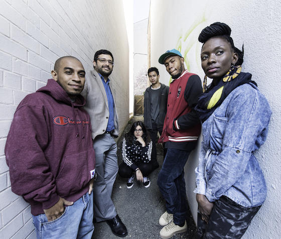 professor standing with group of artists