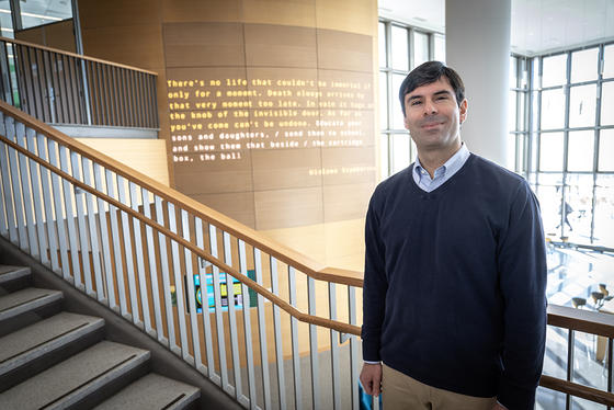 Craig Zaccaro stands in front of the Word Wall in Horizon Hall
