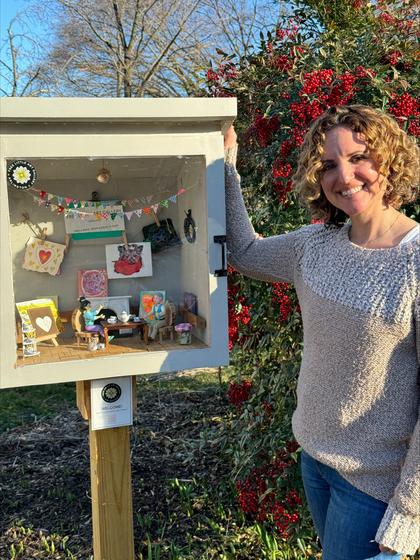 Stacey Schwartz stands next to her Free Little Art Gallery