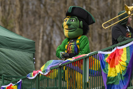 The Patriot mascot wearing a pride shirt at the 2022 Mason Pride Game