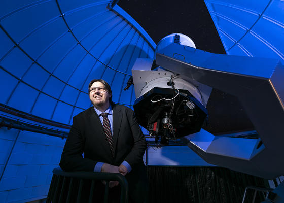 Landolt Mission Principal Investigator, Peter Plavchan stands beside a massive telescope