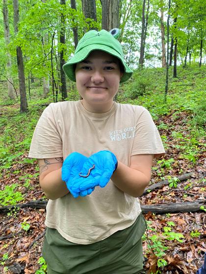 Student holds a salamander