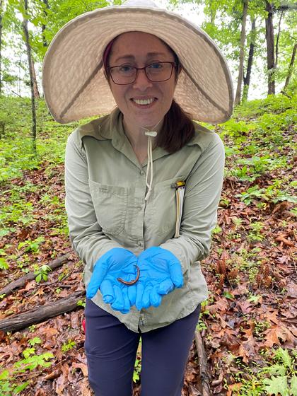 Student holds a salamander