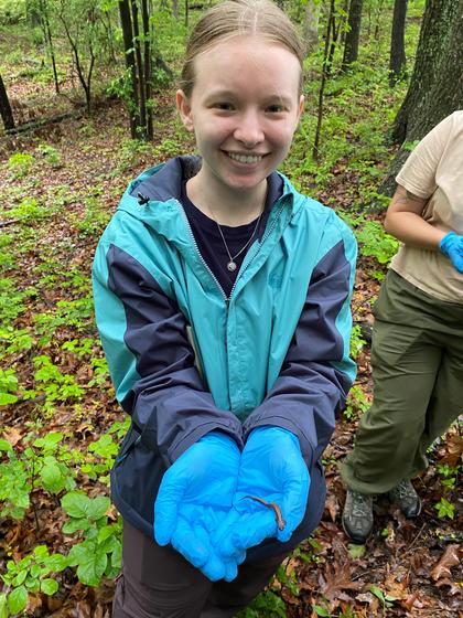 Student holds a salamander