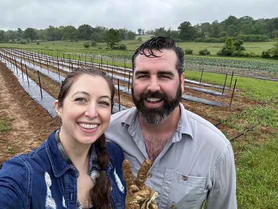 Carissa and Justin O'Neill in a field at JK Community Farm