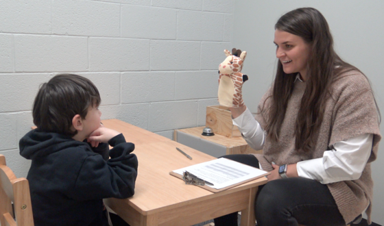 Doctoral student working with child