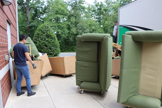 Furniture is loaded onto a truck from a campus residence hall