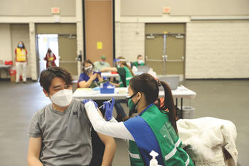 person receiving vaccine by a School of Nursing student