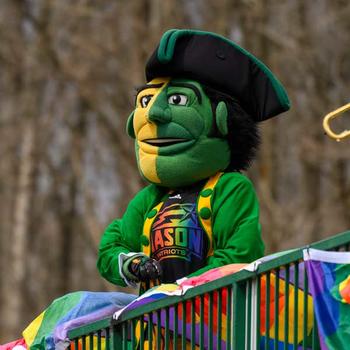 The Patriot mascot dressed in rainbow colors