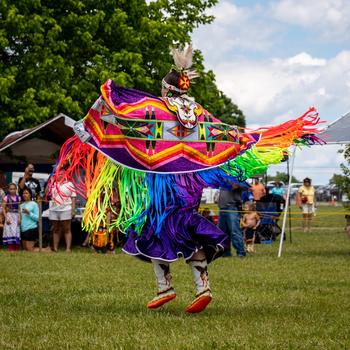 A woman in traditional Upper Mattaponi dress dances at an Upper Mattaponi Powwow.