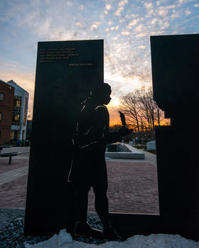 A close up photo of James from the Enslaved People of George Mason Memorial. His cutout figure is holding a quill for George Mason.